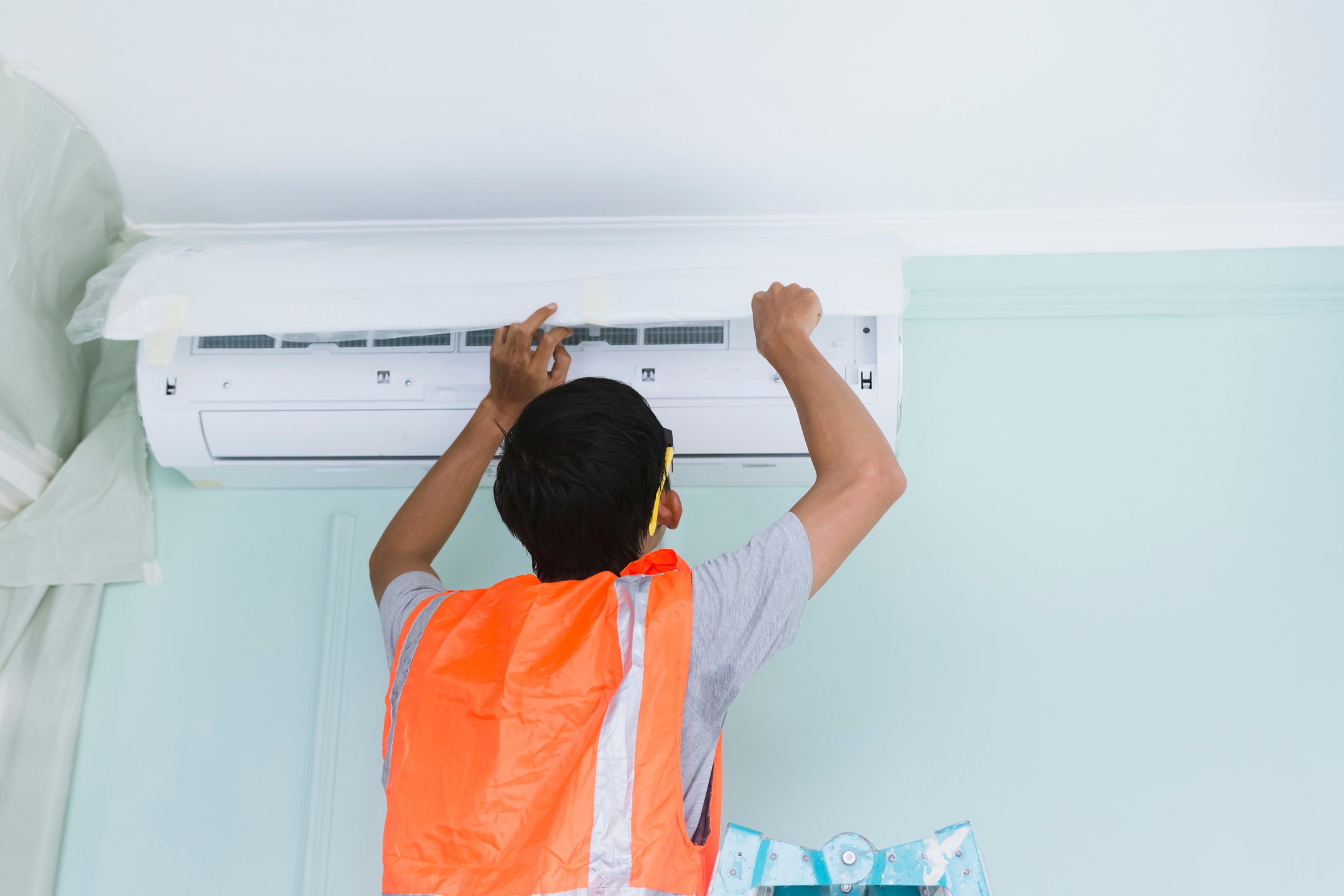 Handyman Repairing the Air Conditioning Unit